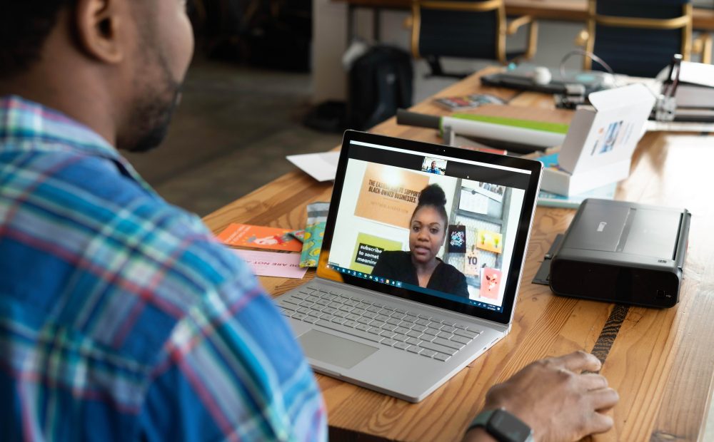 Two people meeting through zoom for work