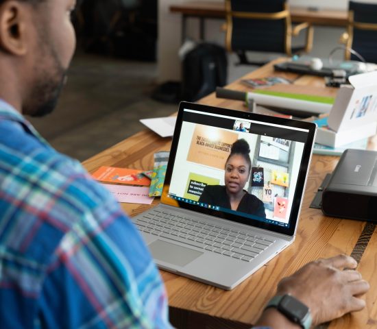 Two people meeting through zoom for work